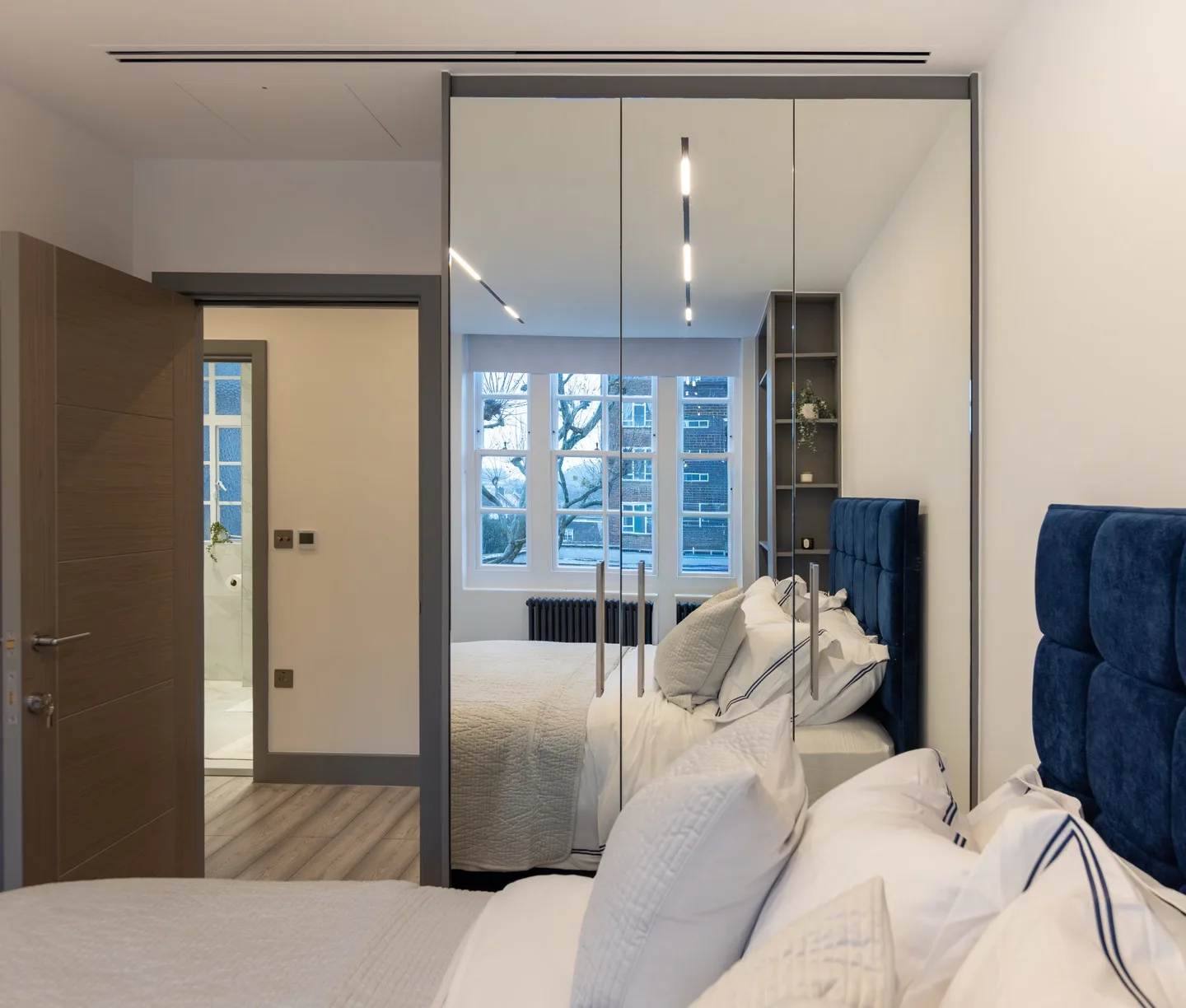 Bespoke fitted wardrobe mirrored doors bedroom — Kensington