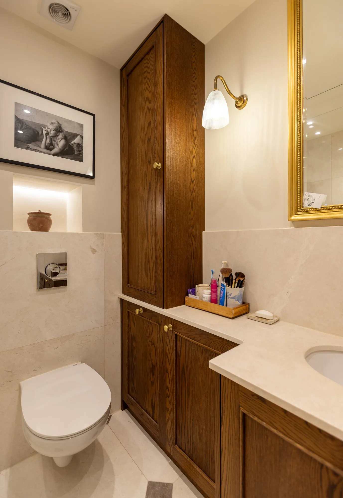 Oak bathroom storage tower and vanity unit with brass wall sconce — Phillimore Gardens, Kensington