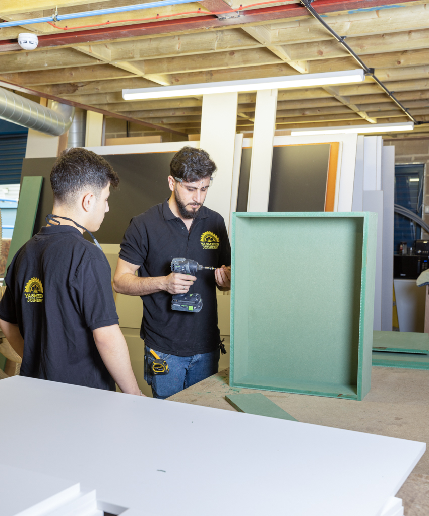 joinery employees assembling a side table.