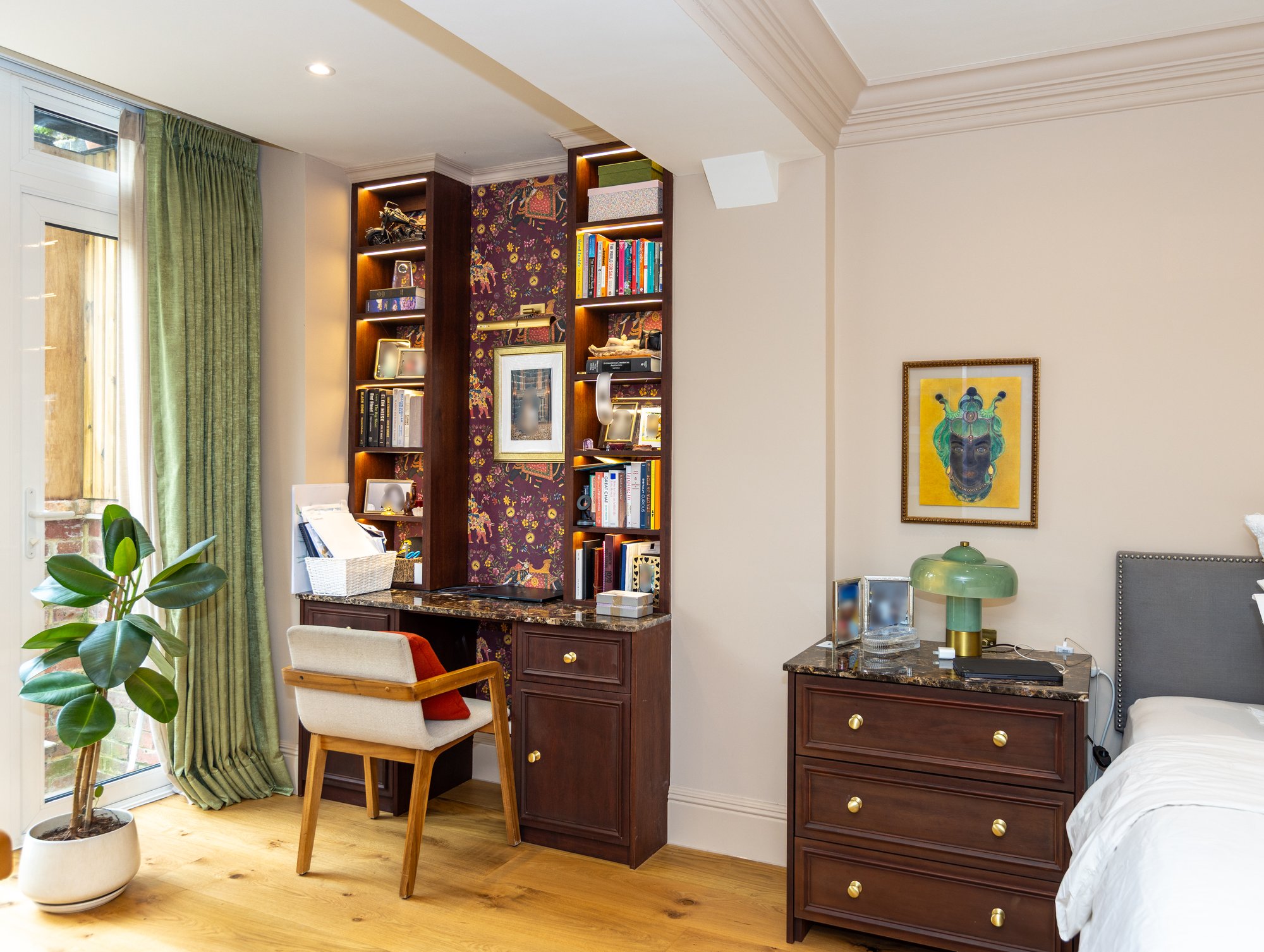 Wide-angle view of a Kensington bedroom featuring bespoke dark oak built-in desk with bookshelves and matching marble-top bedside chest of drawers